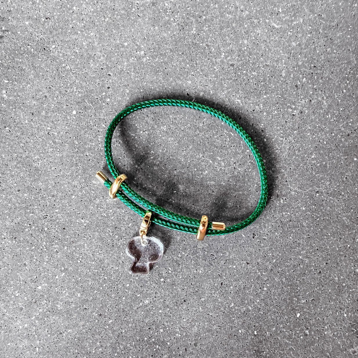 65b2bb63f348b87cbe1f70aa_clover-maven-49-clear-mushroom-glass-charm-on-green-adjustable-bracelet_1784391192134.jpg