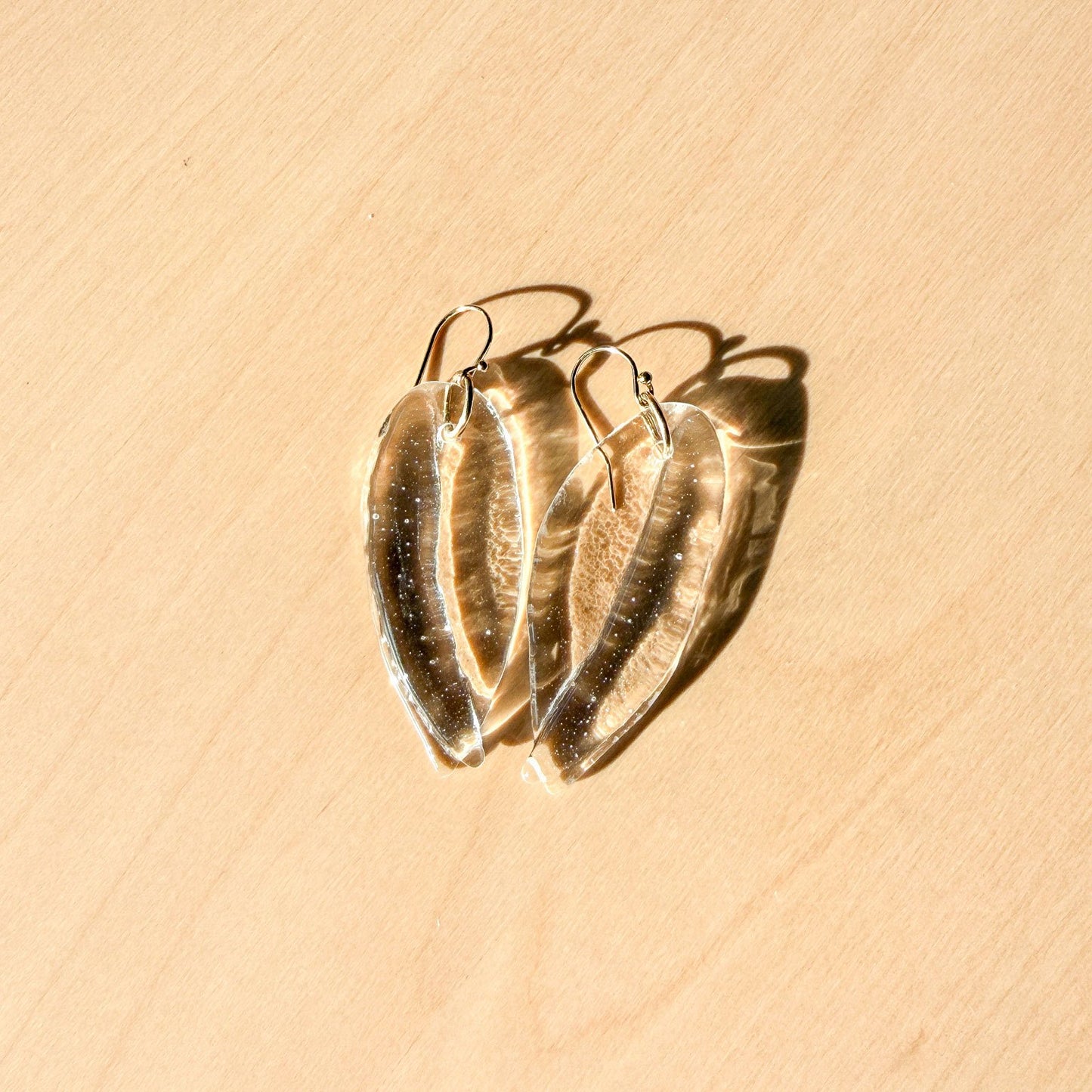 65b2bb63f348b87cbe1f70aa_clover-maven-5-clear-glass-petal-earrings-2_1784396955199.jpg