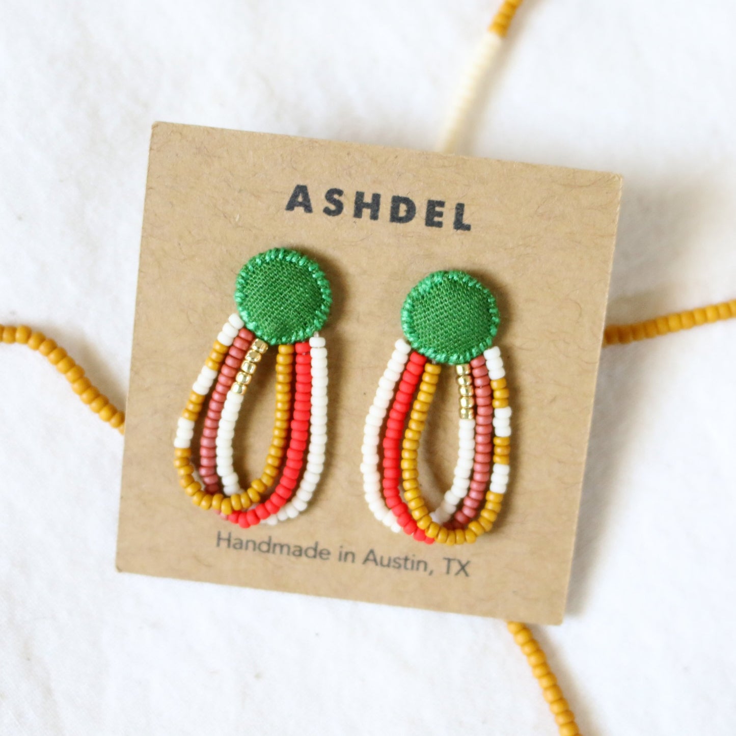 65b2bb63f348b87cbe1f70aa_ashdel-loop-drop-studs-green_1773336190221.jpg