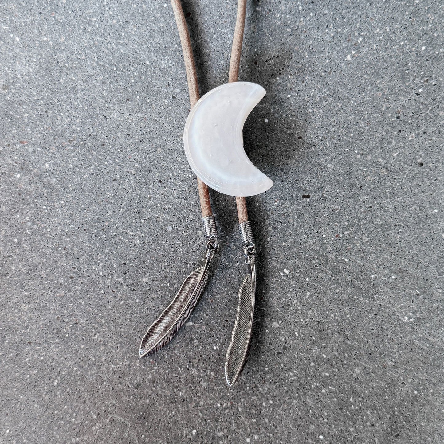 65b2bb63f348b87cbe1f70aa_clover-maven-10-glass-bolo-tie-cream-moon-tan-cord-silver-tips_1784383446924.jpg