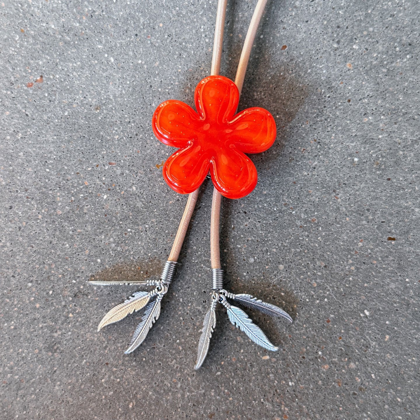 65b2bb63f348b87cbe1f70aa_clover-maven-14-glass-bolo-tie-red-flower-tan-cord-silver-tips_1784383446924.jpg
