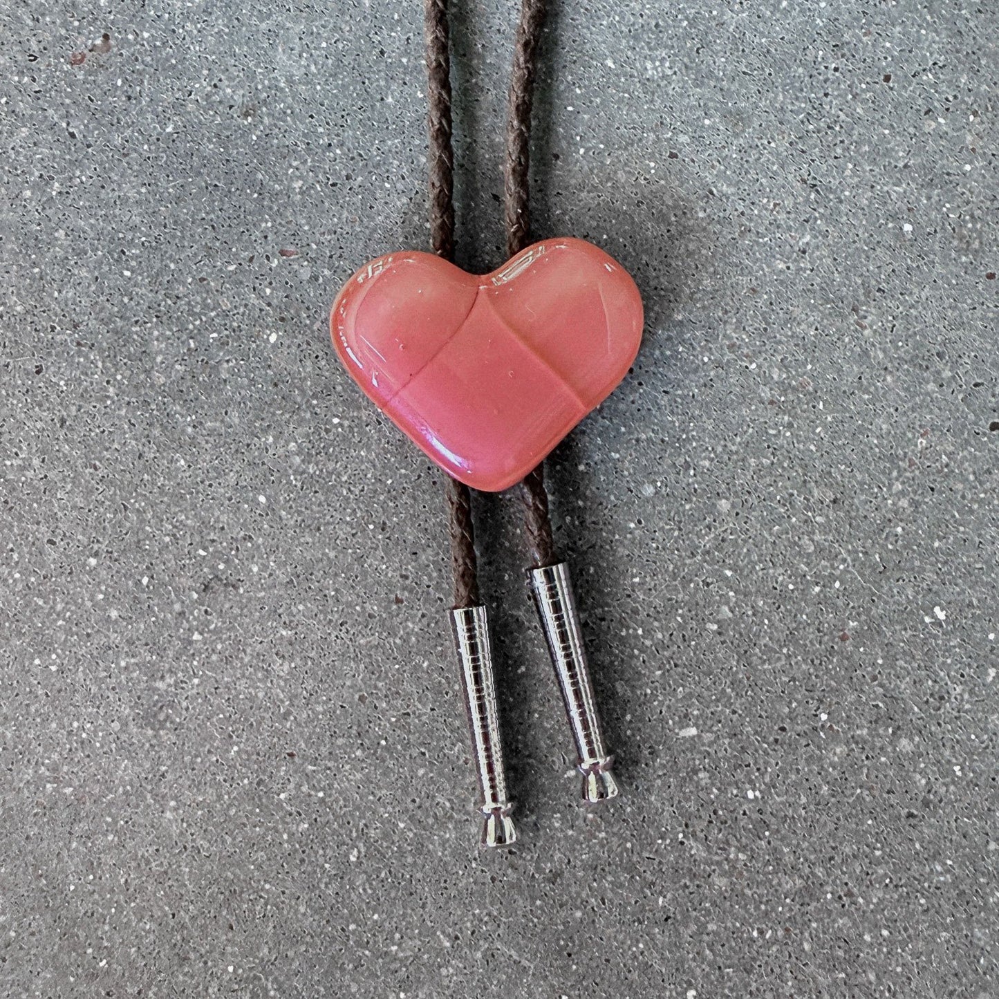65b2bb63f348b87cbe1f70aa_clover-maven-15-glass-bolo-tie-pink-heart-brown-cord-silver-tips_1784383446924.jpg