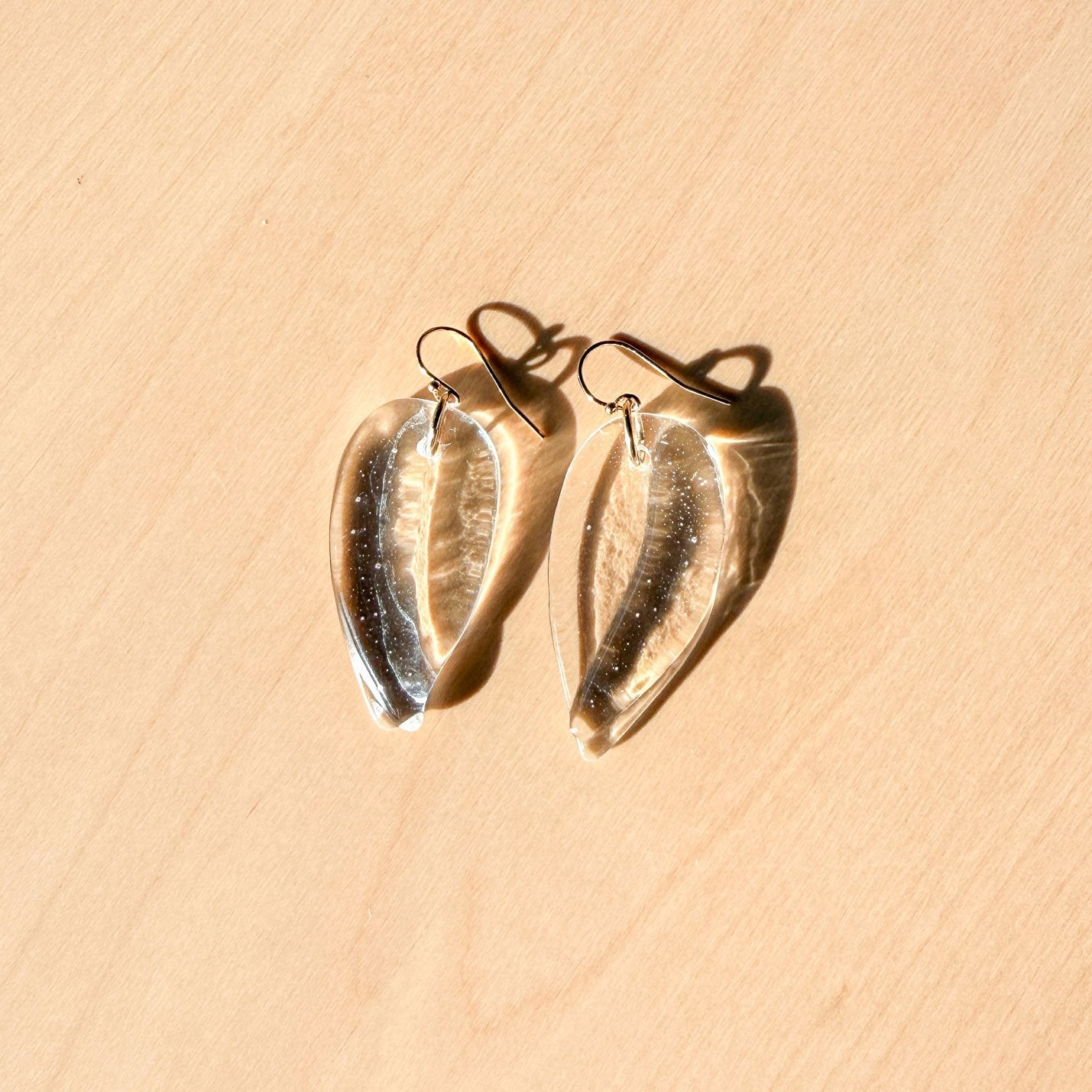 65b2bb63f348b87cbe1f70aa_clover-maven-4-clear-glass-petal-earrings-1_1784396955199.jpg