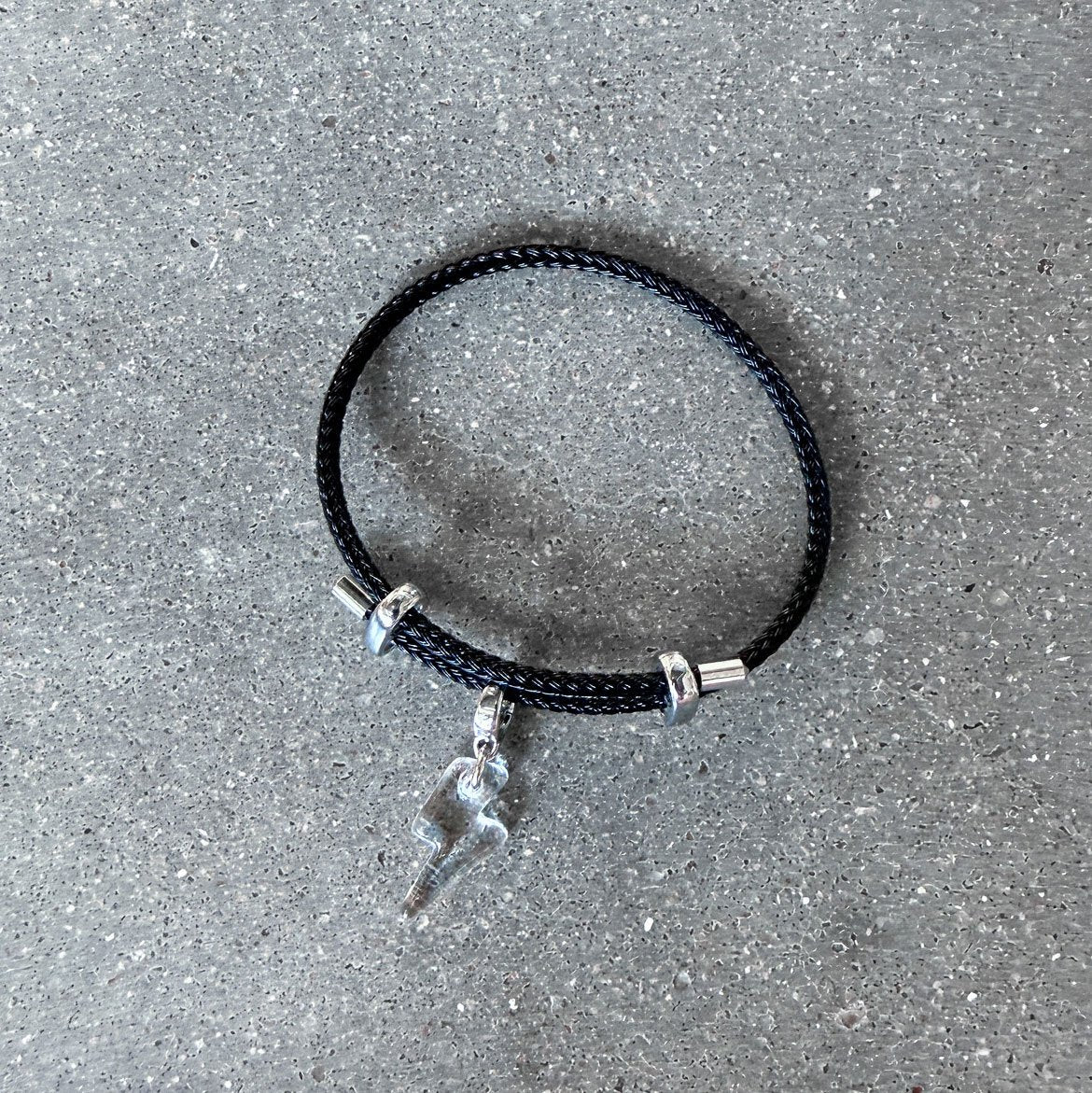 65b2bb63f348b87cbe1f70aa_clover-maven-46-lightning-bolt-glass-charm-on-black-adjustable-bracelet_1784391192134.jpg