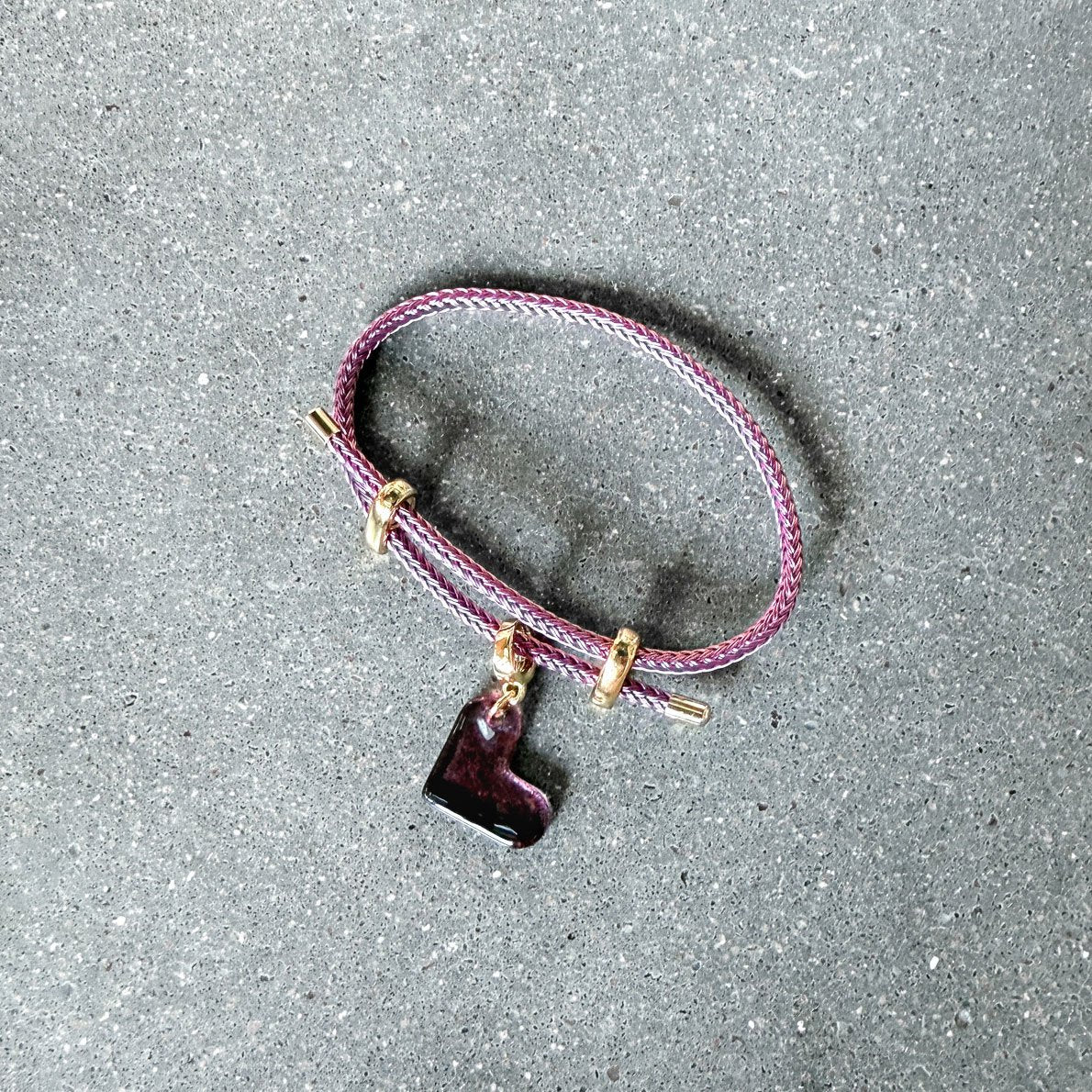 65b2bb63f348b87cbe1f70aa_clover-maven-47-purple-glass-heart-charm-on-purple-adjustable-bracelet_1784391192134.jpg