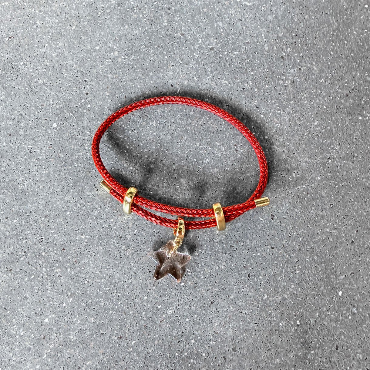 65b2bb63f348b87cbe1f70aa_clover-maven-48-red-star-glass-charm-on-red-adjustable-bracelet_1784391192134.jpg