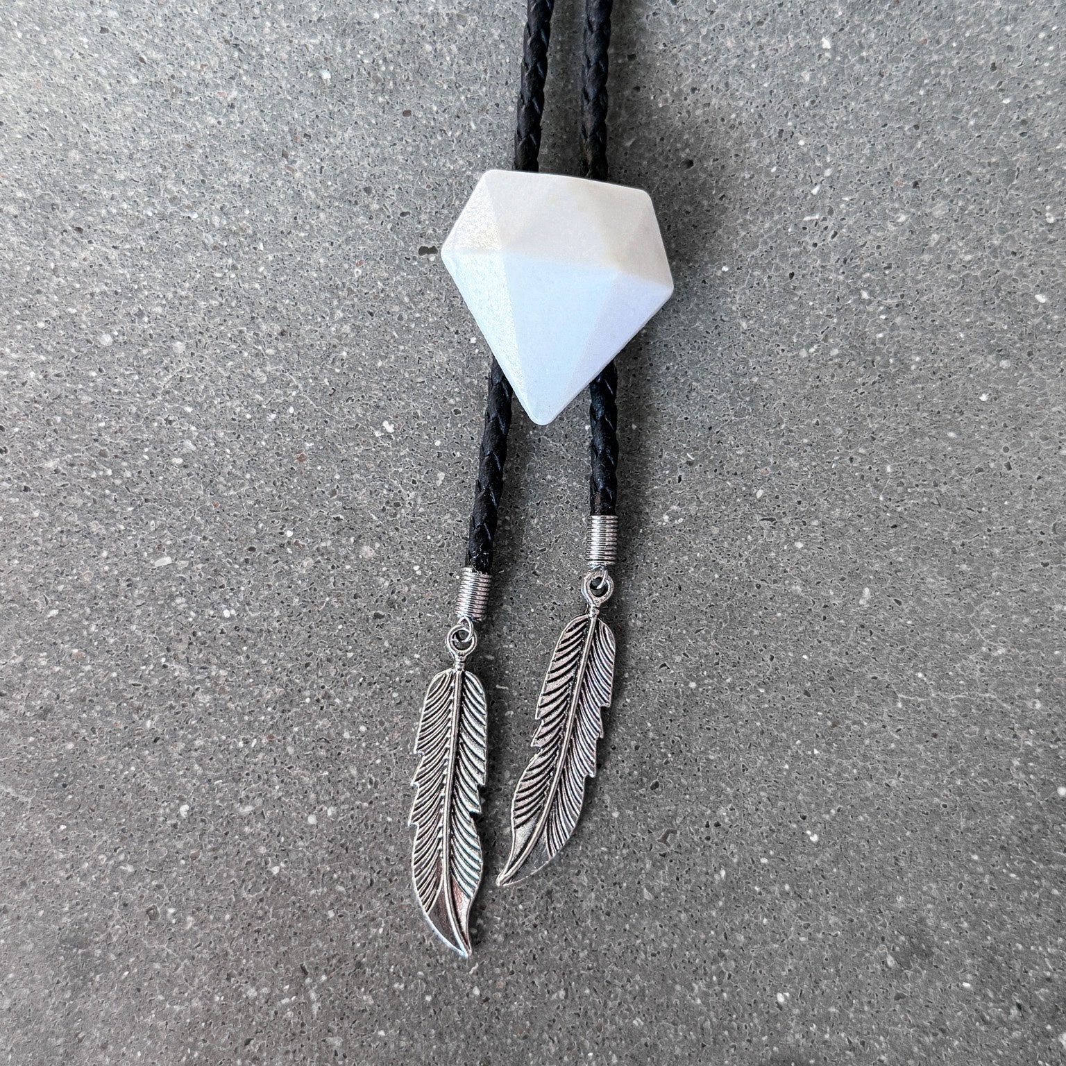 65b2bb63f348b87cbe1f70aa_clover-maven-7-glass-bolo-tie-white-gem-black-cord-silver-tips_1784393137768.jpg