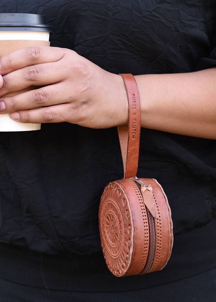65b2bb63f348b87cbe1f70aa_embossed-circle-wristlet-brn-ed_1755697737810.png