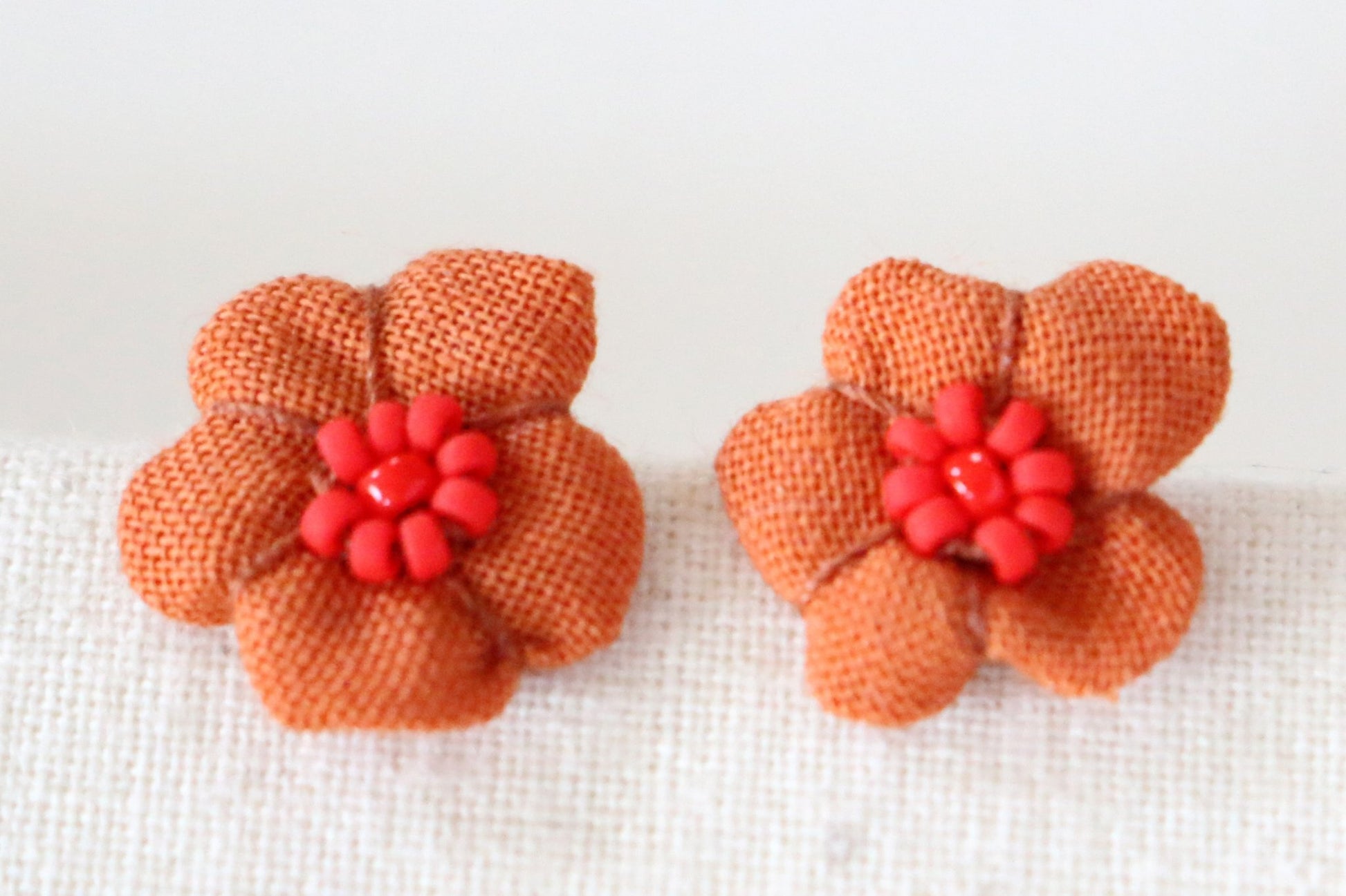 65b2bb63f348b87cbe1f70aa_flower-bud-studs-orange_1773335382297.jpg