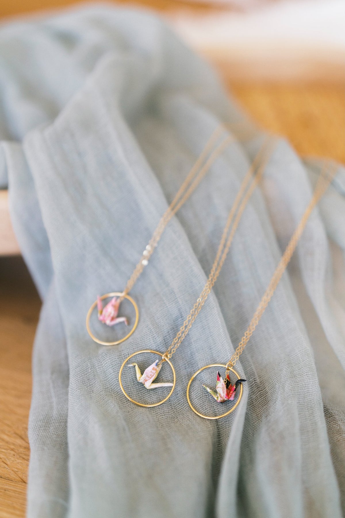 65b2bb63f348b87cbe1f70aa_mimisorigamis-products-hoop-crane-necklace_1790796332939.jpg